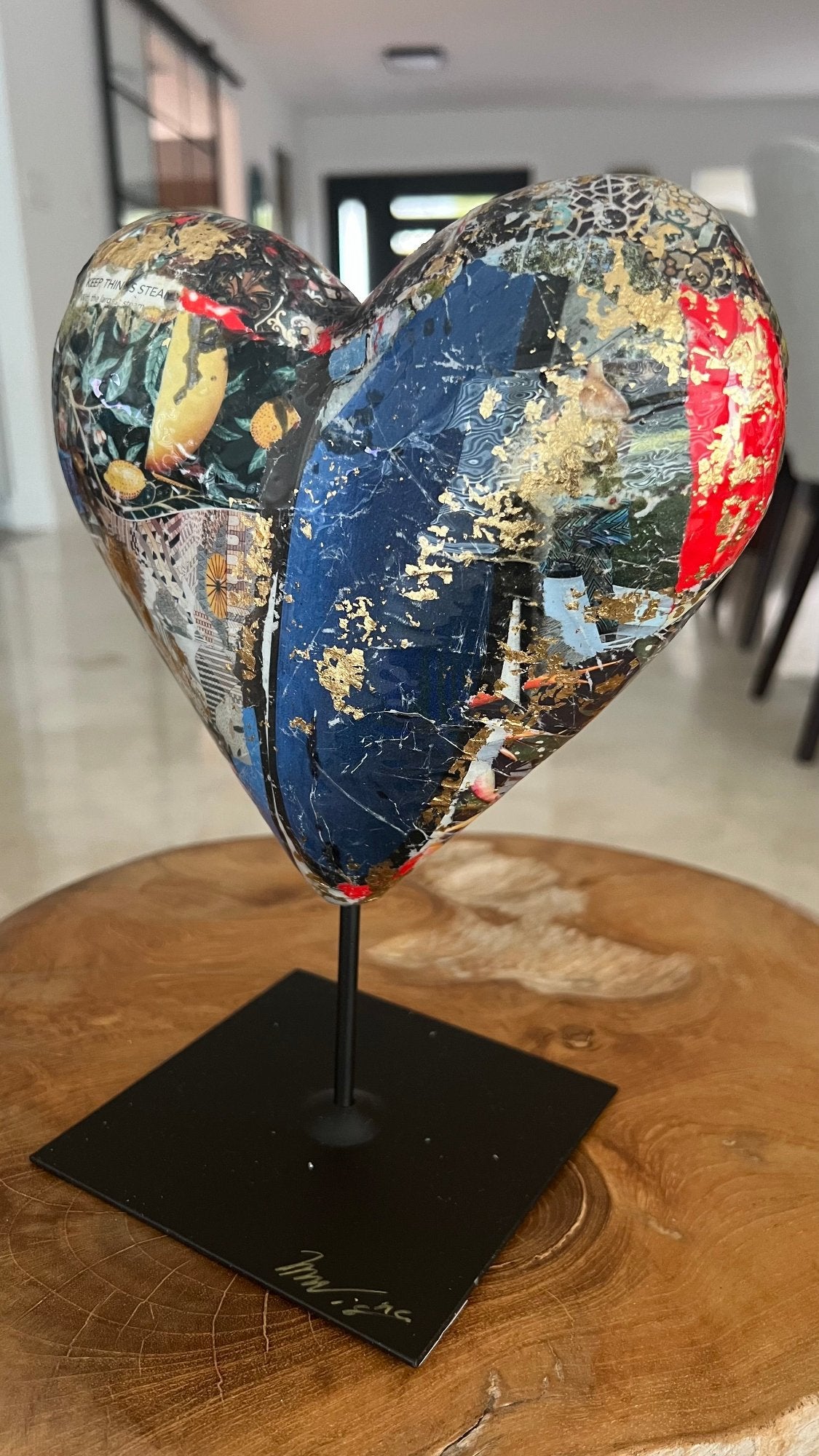 Handcrafted heart-shaped sculpture with mixed media collage and gold leaf embellishments